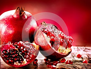 Pomegranates over Red Background photo