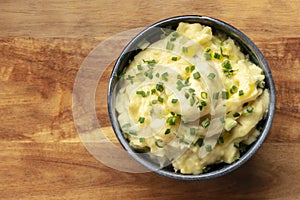 Pomme puree, a bowl of mashed potatoes with scallions and thyme photo