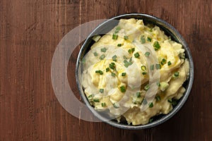 Pomme puree, a photo of a bowl of mashed potatoes with scallions photo