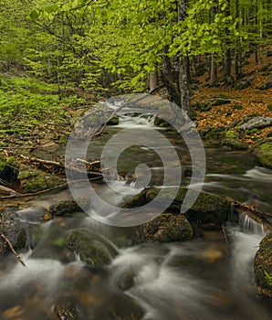 Pommerbach creek in spring cloudy evening near Buchenau village photo