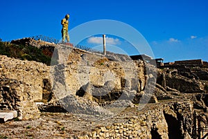 The Pompeii ruins city with the statue of the Apollon in front of Forum