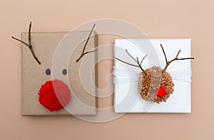 Pompom reindeer gift boxes on brown paper