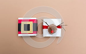 Pompom reindeer and santa belt gift boxes on brown paper