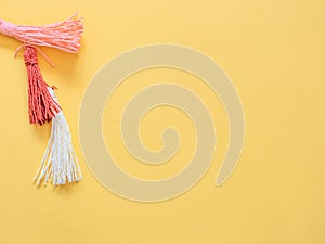 Pompoms on yellow with copy space