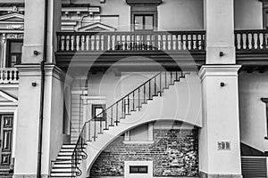 Pompous building facade of the Palace Grand Dukes of Lithuania features stairs on an arch below a balcony with wooden handrail