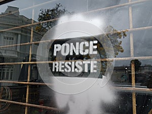 Ponce resist sign spray painted on window in Ponce Puerto Rico