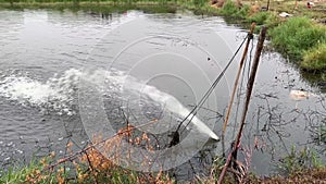 The pond is being watered by machine for oxygen of the fish.