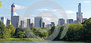 Pond in the central park in NYC. Central Park and Manhattan Skyline. Midtown Manhattan skyline viewed from Central Park