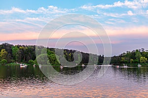 A pond in a city park Tsaritsino on a summer evening with people on boats. Moscow, Russia