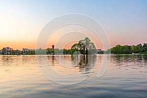 A pond in a city park Tsaritsino on a summer evening with people on boats. Moscow, Russia