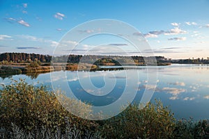 Pond in countryside in autumn at sunset