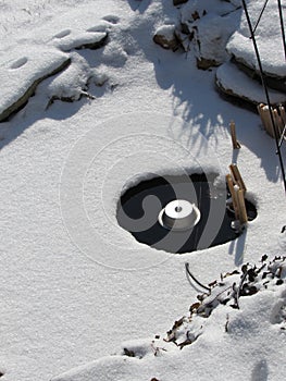 Pond with an electric heater melting the ice in winter