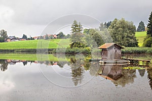 A pond with a fischer hut