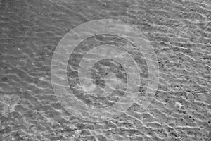 Pond grey water texture with small waves in blank and white.