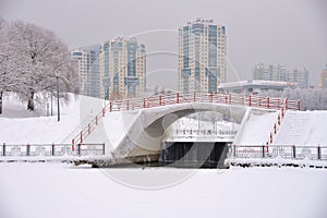 Pond of Olympic Village Park after heavy snowfall in winter, Moscow, Russia