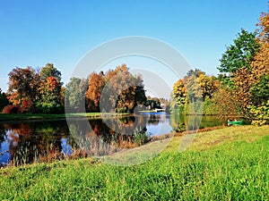A pond in a park on a sunny autumn day