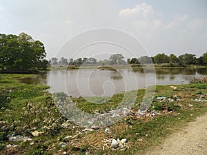 A pond rounded by tree plant in madhubani India photo