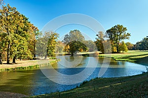 Pond and trees in the garden of the Muskauer park