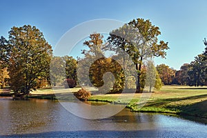 Pond and trees in the garden of the Muskauer park during autumn