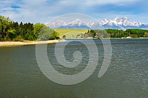 Pond in the village of Vrbov in Slovakia with Hight Tatras mountains on horizon