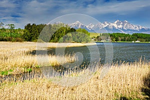 Pond in the village of Vrbov in Slovakia with Hight Tatras mountains on horizon