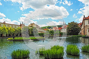 A pond in the Wallenstein Garden in Prague with a marble fountain with statues of Hercules and the Naiads.