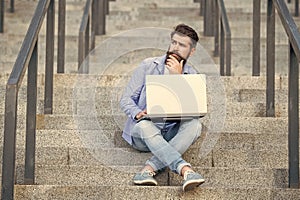 pondering freelancer man with laptop. freelancer man has online laptop communication