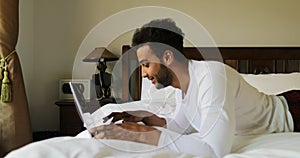 Pondering Man Using Laptop Computer Lying On Bed Hispanic Guy Type Chatting Online In Bedroom Morning