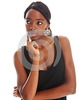 Pondering my future aspirations. Thoughtful young African woman daydreaming over a white background.