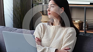Pondering Woman Working With Laptop At Home