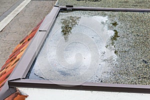 Ponding standing water on a flat roof after heavy rain