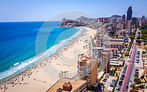 Poniente beach of Benidorm in summer seen from the heights of a skyscraper with the beach, the sea and other buildings of hotels photo