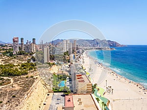 Poniente beach of Benidorm in summer seen from the heights of a skyscraper with the beach, the sea and other buildings of hotels photo
