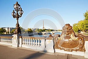 Pont Alexandre III bridge balustrade with Eiffel tower in Paris