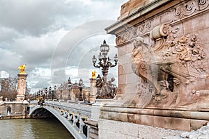 The Pont Alexandre III is a deck arch bridge that spans the Seine in Paris