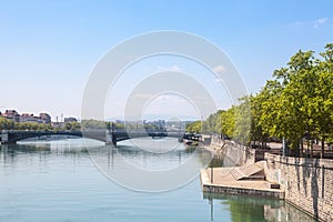 Pont de l`Universite bridge in Lyon, France over a panorama of the riverbank of the Rhone river Quais de Rhone