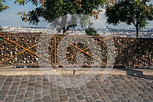 Pont des Arts steel Bridge with thousand of Love Padlocks with tiled floor street in Paris, France