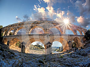 Pont du Gard against sunset is an old Roman aqueduct in Provence, France