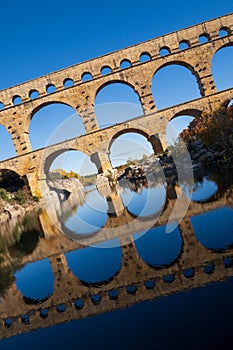 The Pont du Gard, vertical photography tilted over blue sky. Ancient Roman aqueduct bridge. Photography taken in Provence,