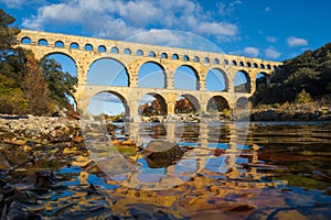 The Pont du Gard viewed from the river. Ancient Roman aqueduct bridge. Photography taken in Provence, southern France