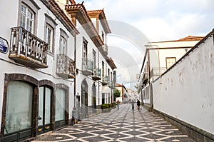 Ponta Delgada, Azores, Portugal - Jan 12, 2020: Cobbled street in the historical center of the Portuguese city. Traditional houses