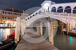 Ponte di Rialto bridge over the Grand Canal in Venice city at night, Italy