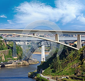 Ponte do Infante, Maria Pia Bridge and St John`s Bridge over Douro river in Porto, Portugal. People are unrecognizable