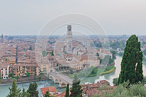 Ponte Pietra over Adige river, with the bell tower of Verona cathedral and the historical center, in Verona, Italy
