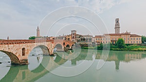 Ponte Pietra over Adige river, with the bell tower of Verona cathedral, in Verona, Italy