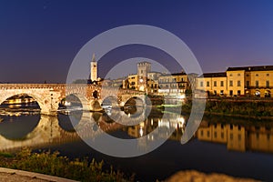 Ponte Pietra over Adige River and city at night. Verona. Italy