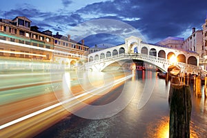 Ponte Rialto and gondola at sunset in Venice, Italy