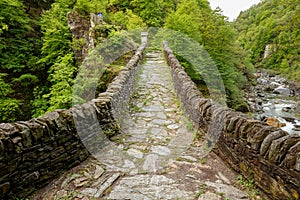 View on the way on Ponte Romano Intragna Bridge hiding in the va photo