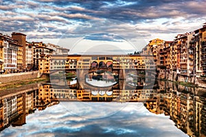 Ponte Vecchio bridge in Florence, Italy. Arno River under romantic sky