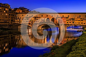 Ponte Vecchio bridge with silversmith shops on Arno at sunset, Florence, Italy